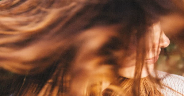 woman smiling waving her hair