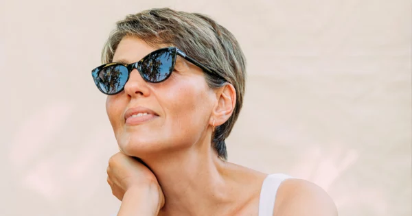 Beautiful woman in her 50s wearing sunglasses.