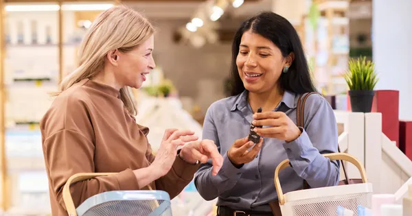two women comparing a product while shopping in a pharmacy